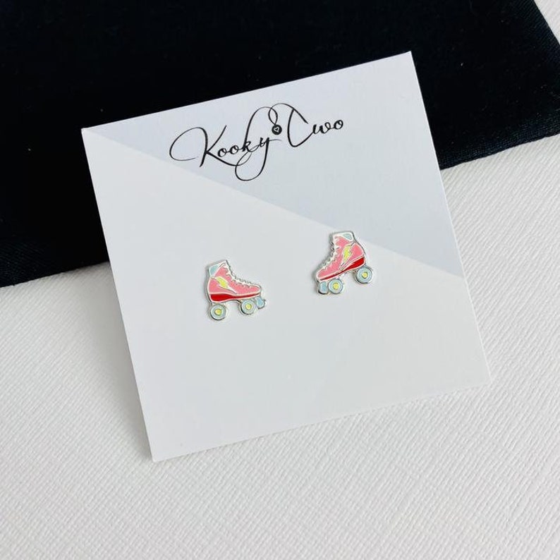 Girls roller skate earrings sterling silver studs with yellow lightning bolt and pink colour boot.