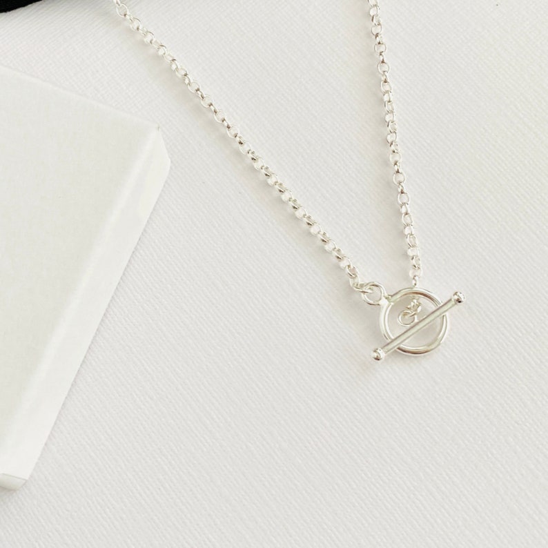 Sterling silver necklace with t bar toggle. Necklace features a circle and t bar connector in sterling silver.