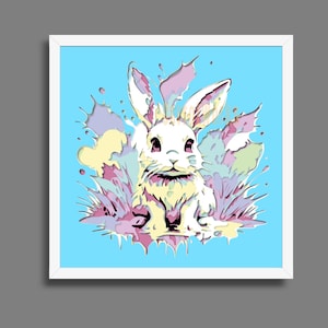 May include: A framed art print featuring a white rabbit illustration with a light blue background. The rabbit is surrounded by colorful splashes of yellow, pink, and purple. The artwork has a modern, pop art style.
