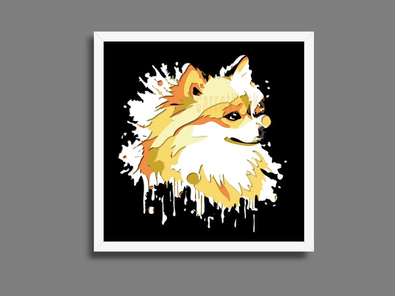 May include: A framed art print depicting a Pomeranian dog in a stylized illustration. The dog is rendered in yellow, orange, and white against a black backdrop with white paint splatter effects. The artwork is presented in a white frame.