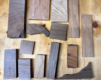 May include: Assortment of wood pieces in various shapes and sizes, including rectangular, square, and curved pieces. The wood is a light brown color with a natural grain pattern.