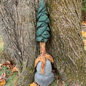 Chainsaw carved tree on a rock wall hanger
