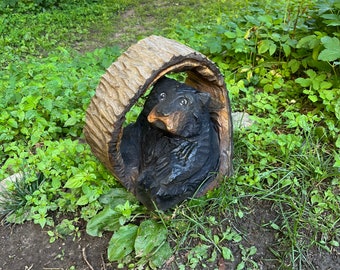 Chainsaw carved bear in a hollow