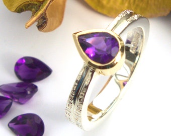 Anillo solitario de amatista en oro y plata con banda con textura de mimbre y detalle de ranura en el hombro