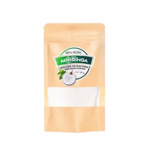 May include: A tan pouch of Moringa baby roots powder. The pouch has a clear window and a green and white label with the words "100% Natural" and "Moringa" in a stylized font. The label also says "Poudre de Racines Baby Roots Powder" and "50 g".