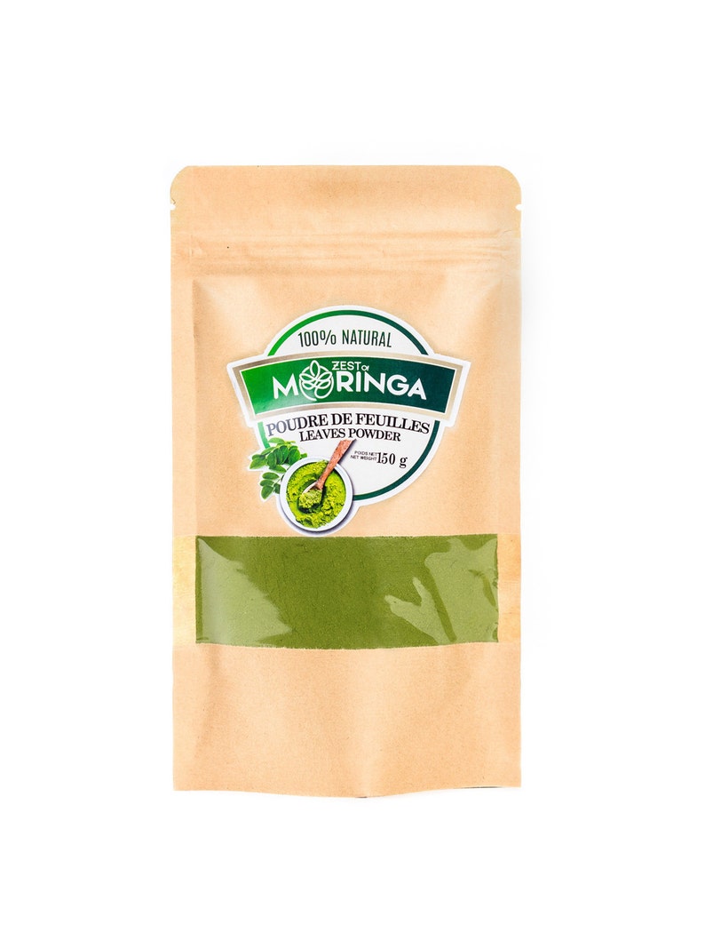 May include: A brown paper pouch with a clear window showing green moringa powder. The pouch has a label that says "100% Natural Zest Moringa Poudre de Feuilles Leaves Powder 150g".