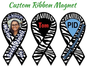 May include: Three black and white zebra patterned ribbon magnets. The first magnet has a photo of a woman with the text "In Memory Of We Love Susan Daniels You". The second magnet has the text "Tom". The third magnet has the text "PID Primary Immune Deficiency" with a blue accent color.