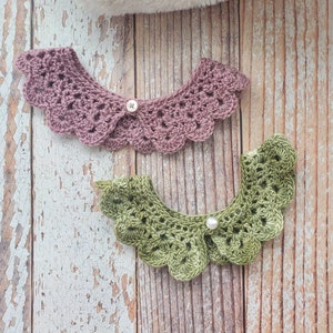 May include: Two handmade crochet collars in the image. One is a dusty rose color, and the other is a light green. Each collar has a scalloped edge and a button or pearl for closure. The collars are displayed on a wooden surface.