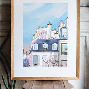 May include: A watercolor painting of a Parisian cityscape with a blue sky and pink flowers. The buildings are white with gray roofs and windows. There are trees in the foreground with pink blossoms.