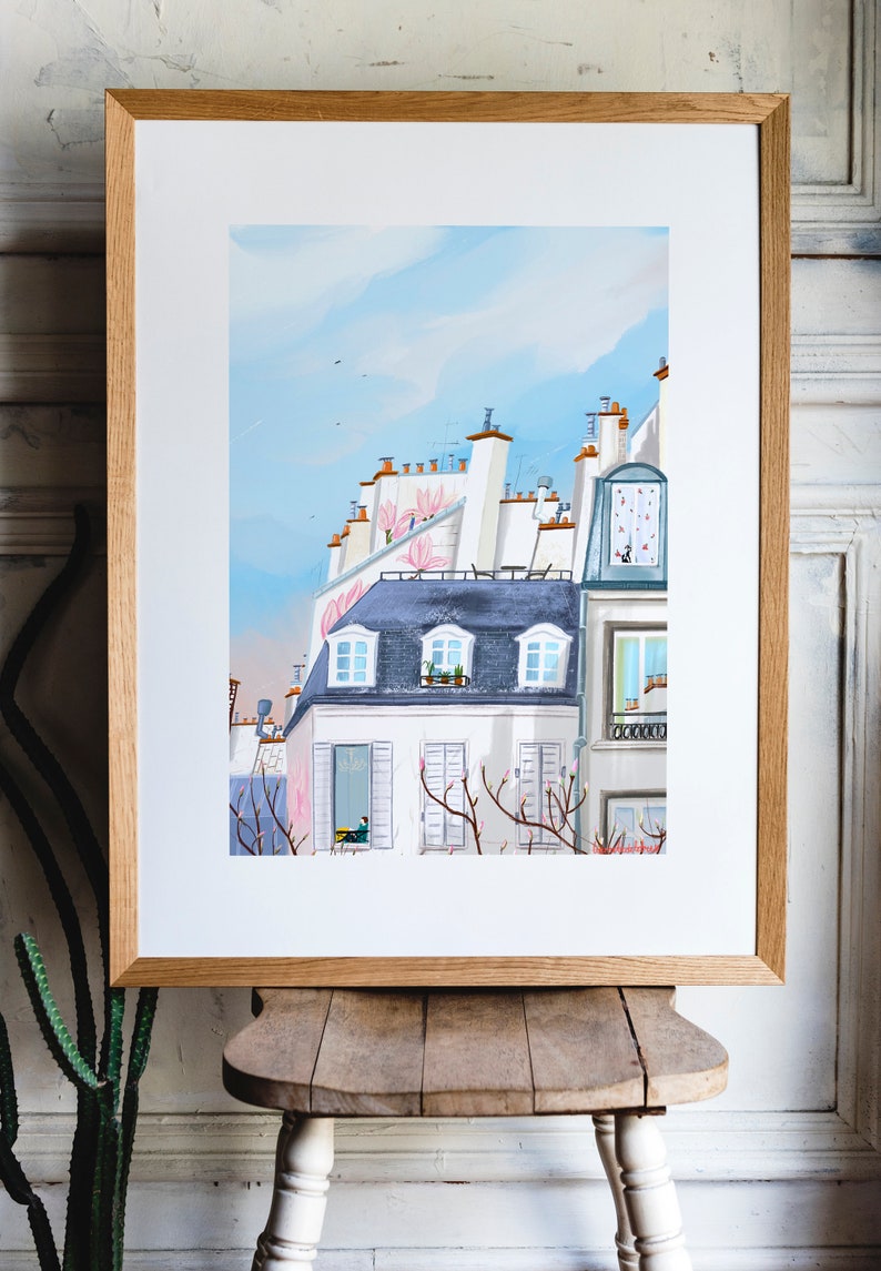 May include: A watercolor painting of a Parisian cityscape with a blue sky and pink flowers. The buildings are white with gray roofs and windows. There are trees in the foreground with pink blossoms.