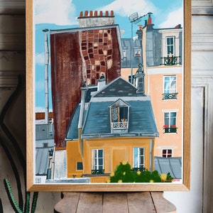 May include: A painting depicting a Parisian cityscape, featuring a yellow building in the foreground with a blue roof and a small balcony with a window. The building is surrounded by other buildings with red brick and brown facades. The sky is blue with white clouds and a bird flying overhead.