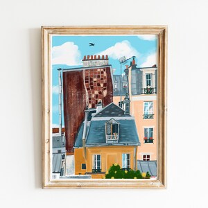 May include: A framed painting depicting a Parisian cityscape with a blue sky, white clouds, and a bird in flight. The painting features a yellow building with a blue roof and a window with a balcony. The building is surrounded by other buildings with red brick and grey stone.