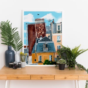May include: A painting depicting a Parisian cityscape with a blue sky and white clouds. The artwork features a tall building with a red brick facade and a smaller building with a yellow facade and a blue roof. Windows and balconies can be seen on the buildings.