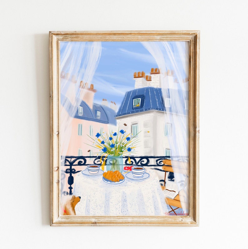 May include: A painting of a Parisian balcony scene with a table set for two, featuring a vase of blue flowers, two cups of coffee, and croissants. The balcony overlooks a cityscape with white buildings and blue rooftops.