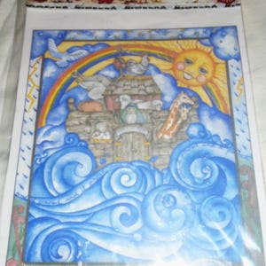 May include: Iron-on transfer design featuring a colorful illustration of Noah's Ark with animals on a stormy sea with a rainbow and a smiling sun. The design is titled "Cache Junction" and is part of a series of iron-on transfers.