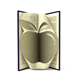 May include: A book with pages folded into the shape of an apple. The book is open and the apple is visible in the center of the image. The book has a blue cover.