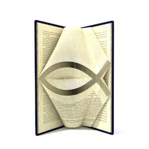 May include: A book with blue covers is folded into the shape of a Christian fish symbol. The pages are folded to create a three-dimensional effect.
