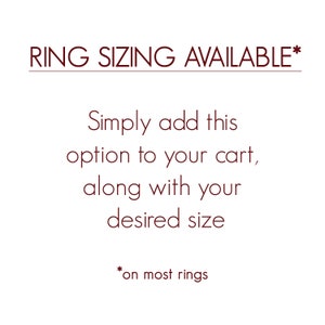 May include: Text that reads "RING SIZING AVAILABLE*" with an asterisk. Below the text, it says "Simply add this option to your cart, along with your desired size."  The text "*on most rings" appears at the bottom of the image.