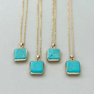 May include: Four gold necklaces with turquoise square pendants. Each necklace has a delicate gold chain and a square pendant with a turquoise stone.