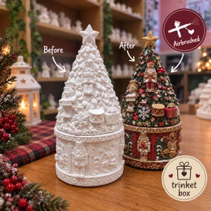 May include: Two conical ceramic trinket boxes shaped like Christmas trees. One is plain white, labelled 'Before', and the other is painted in green, red, and gold, labelled 'After'. Both feature nutcracker and toy motifs with a star topper.