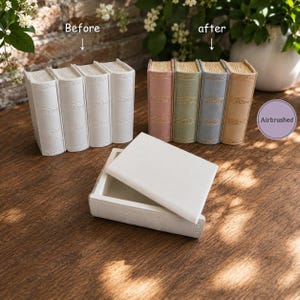 May include: A set of four white book-shaped boxes labeled Before, a set of four pastel-colored book-shaped boxes labeled after, and a single white book-shaped box with a removable lid. A purple circle with the text Airbrushed is visible.