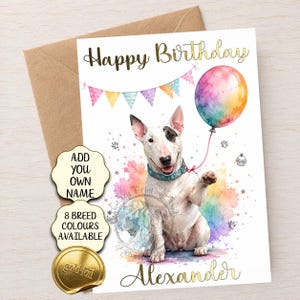 May include: A white Bull Terrier birthday card featuring the text Happy Birthday and Alexander in gold foil. The dog wears a blue collar and holds a colorful watercolor balloon. Above the dog are pastel bunting flags and small paw prints.