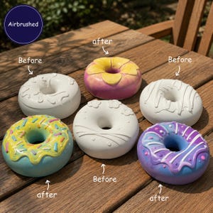 May include: Six donut-shaped objects arranged on a wooden surface. Three are plain white with raised textures labeled 'Before', and three are airbrushed with colorful paint and sprinkles labeled 'after'. Text includes 'Airbrushed', 'Before', and 'after'.