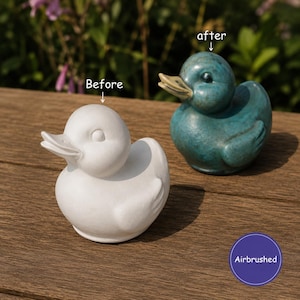 May include: Two duck figurines are displayed. One is a plain white, unpainted duck labelled 'Before'. The other is a teal-coloured duck with a light-coloured beak labelled 'after'. A purple circle in the corner contains the text 'Airbrushed'.