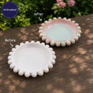 May include: Two circular trays with beaded edges. One tray is plain white. The other tray is airbrushed with a light green interior, a pink rim, and alternating pink and green beads along the edge, featuring the text Airbrushed, after, and Before.