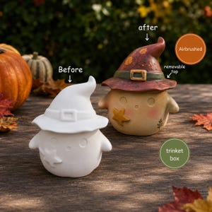 May include: Two ceramic trinket boxes shaped like round figures wearing witch hats. One is plain white, labeled Before. The other is airbrushed with a brown hat, a green belt, a yellow star, and a removable top, labeled after and removable top.