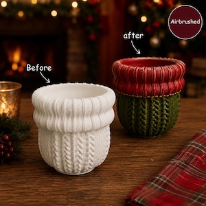 May include: Two cylindrical pots with a textured knit pattern. The left pot is solid white. The right pot is painted with a red rim and a green base, featuring a gold beaded accent line. Text labels read Before, after, and Airbrushed.