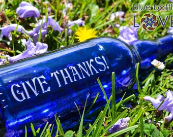 Give Thanks blue glass water bottle