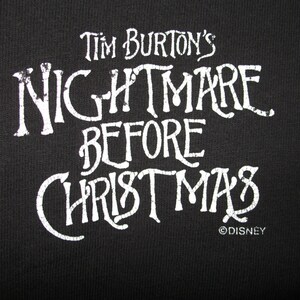 May include: White text on a black background reads "Tim Burton's Nightmare Before Christmas" with the Disney copyright symbol below.