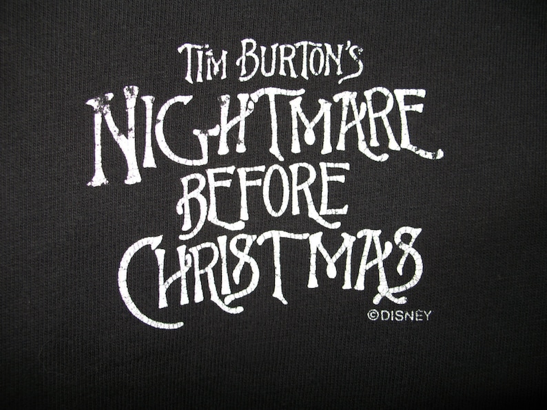 May include: White text on a black background reads "Tim Burton's Nightmare Before Christmas" with the Disney copyright symbol below.