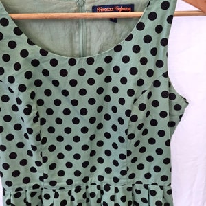 green and black polka dot pleated dress