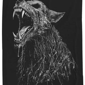 May include: A black fabric item featuring a detailed white ink illustration of a snarling wolf with its mouth wide open, revealing sharp teeth and a tongue. The wolf's fur appears textured with dripping, liquid-like strokes in a high-contrast style.