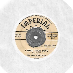 May include: A vintage 45 RPM record label for the song "I Need Your Love" by Pee Wee Crayton. The label is beige with black text and a black star design. The label is for Imperial Records, Commodore Music Corp., and has the catalog number K5321.