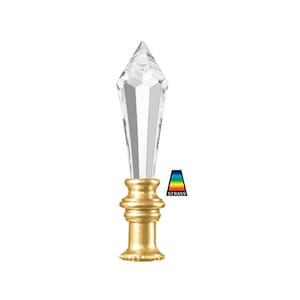 May include: A clear crystal finial with a gold metal base. The finial is shaped like a pointed teardrop and has a faceted design. The base is a simple cylinder with a decorative edge.