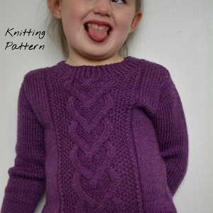 May include: A purple knitted sweater with a cable knit pattern. The sweater has a round neckline and long sleeves.