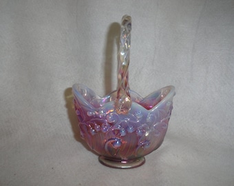 May include: A pink iridescent glass candy dish with a twisted handle and a lily of the valley design.