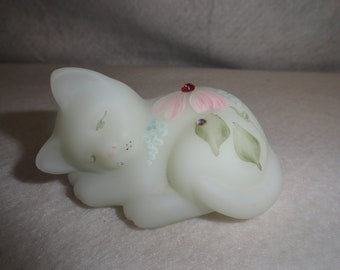 May include: A sleeping white milk glass cat figurine with hand-painted floral details and rhinestones.