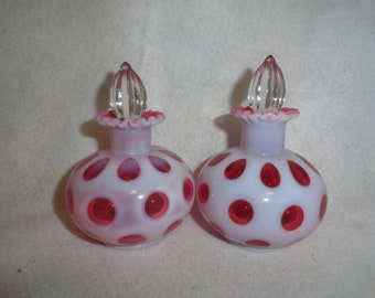 May include: Two vintage milk glass perfume bottles with red polka dots and clear glass stoppers.