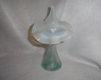 May include: A white opalescent glass vase with a ruffled top and a textured green base.
