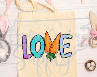 May include: A tote bag with a light brown canvas background featuring a colorful graphic of the word "LOVE" with two carrots in the center. The carrots are orange and green.