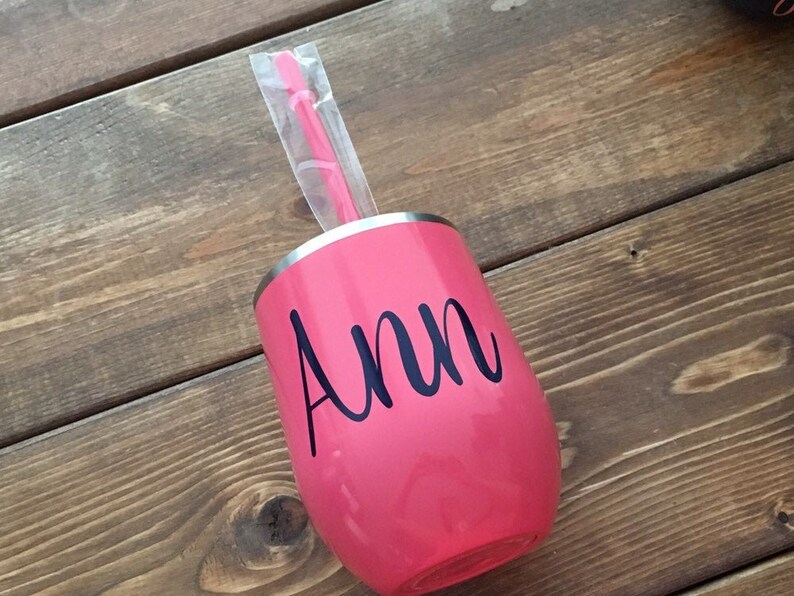 May include: Pink stainless steel wine tumbler with a black vinyl decal that says "Ann".