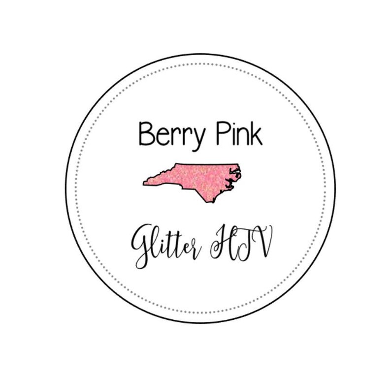 May include: A round sticker with a pink glitter outline of the state of North Carolina. The text "Berry Pink Glitter HTV" is written below the state outline.