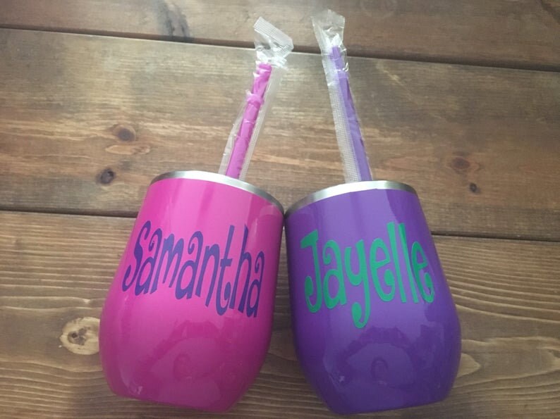 May include: Two stainless steel tumblers with personalized names, "Samantha" and "Jayelle", in purple and pink with matching straws.