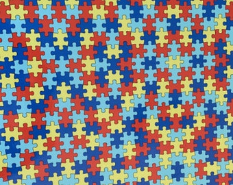 May include: A repeating pattern of puzzle pieces in blue, red, and yellow. The puzzle pieces are arranged in a diagonal pattern.