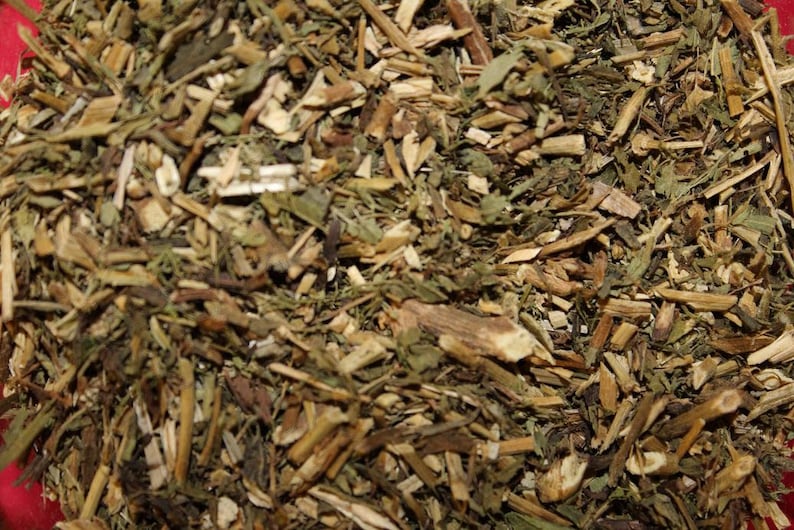 May include: A close-up of a mixture of dried herbs and roots, including green leaves, brown stems, and light brown pieces of bark.