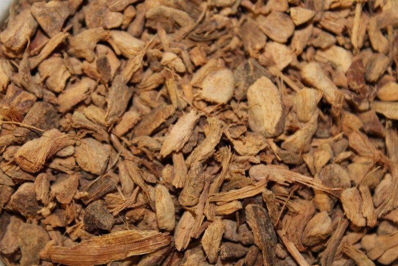 May include: Close-up of dried, brown, and tan pieces of ginger root.